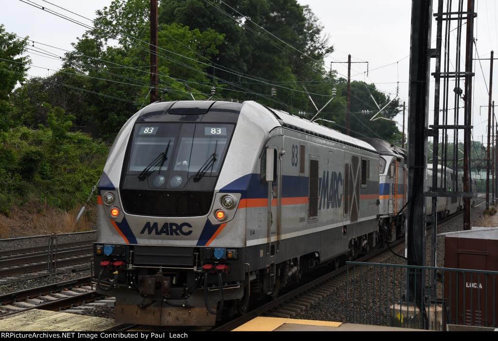 Commuter shoves out of the station behind a pair of locos